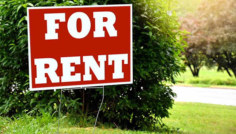 For Rent sign in a yard (Photo via Envato Elements)