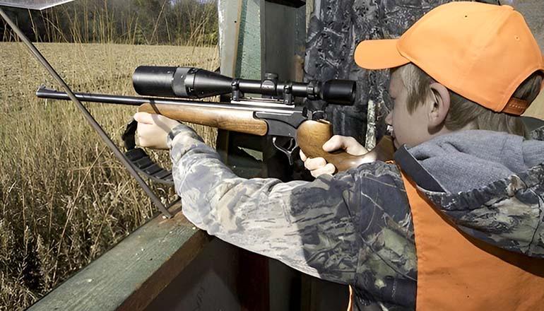 Young hunter with a rifle and scope